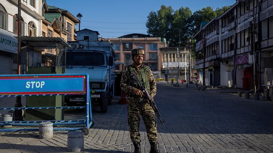 <div class="paragraphs"><p>An Indian security force personnel stands guard on a street, following an attack on tourists near Pahalgam in south Kashmir, in Srinagar, April 29, 2025.</p></div>