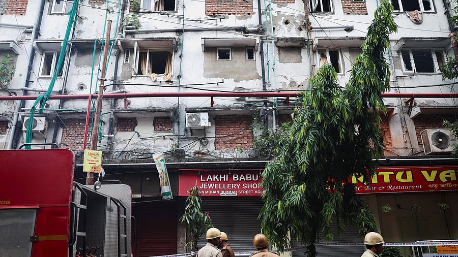 <div class="paragraphs"><p>Firefighters inspect the aftermath of a hotel fire that killed several people in Kolkata, India,</p></div>