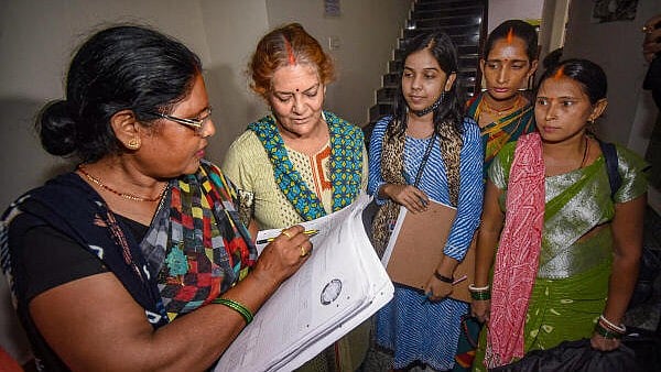 <div class="paragraphs"><p>Enumerator staff collects information from residents for a caste-based census in Bihar.</p></div>