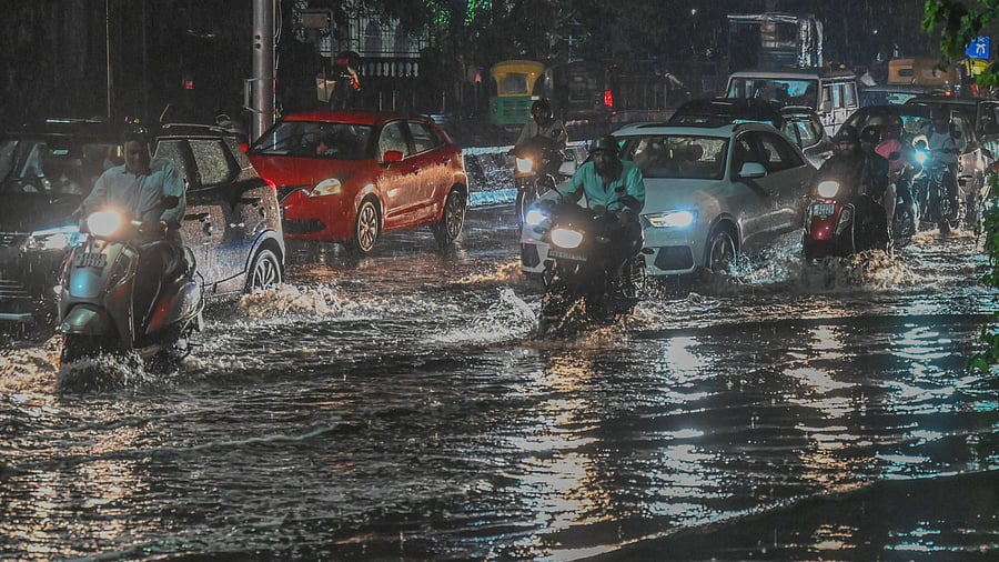 <div class="paragraphs"><p>Vehicles wade through a rain-soaked Anil Kumble Circle as showers turn roads into shallow streams in Bengaluru on Thursday. </p></div>