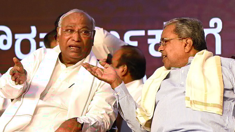 <div class="paragraphs"><p>Chief Minister Siddaramaiah shares a word with AICC president Mallikarjun Kharge at a programme to mark May Day, in Bengaluru on Thursday. </p></div>