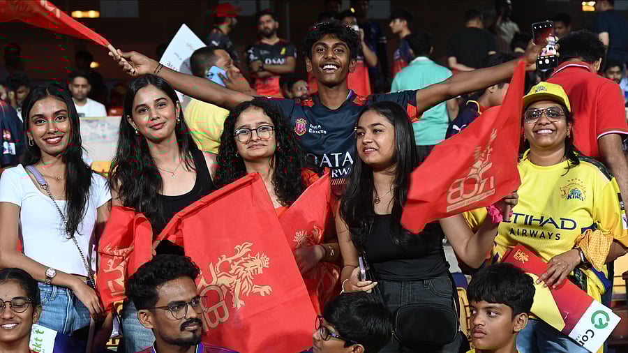 <div class="paragraphs"><p>Cricket fans cheer during the IPL match between RCB and CSK at M Chinnaswamy Stadium on Saturday. </p></div>