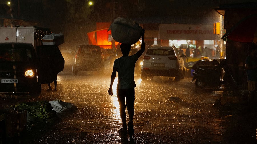 <div class="paragraphs"><p>A man carries flowers for sale during rain at a wholesale market in New Delhi, India May 2, 2025.</p></div>