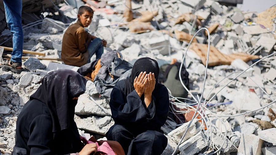 <div class="paragraphs"><p>Palestinians react as they inspect the site of an Israeli strike on a house amid the ongoing conflict between Israel and Hamas, in Khan Younis in the southern Gaza Strip, June 3, 2024. </p></div>