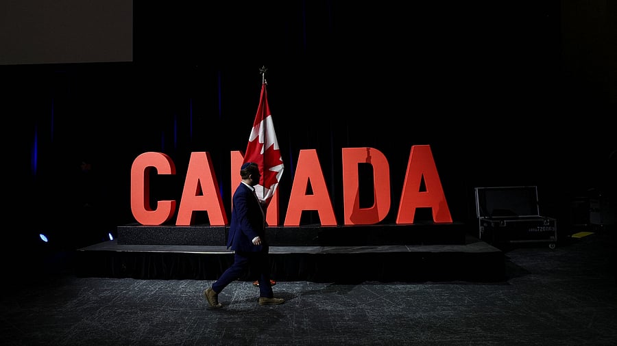 <div class="paragraphs"><p>A man carries a Canadian flag.</p></div>