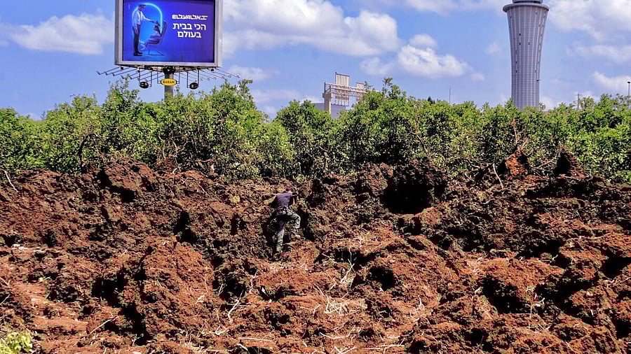 <div class="paragraphs"><p>An Israeli police officer investigates a crater at the site of a missile attack, launched from Yemen, near Ben Gurion Airport, in Tel Aviv, Israel May 4, 2025.&nbsp;</p></div>
