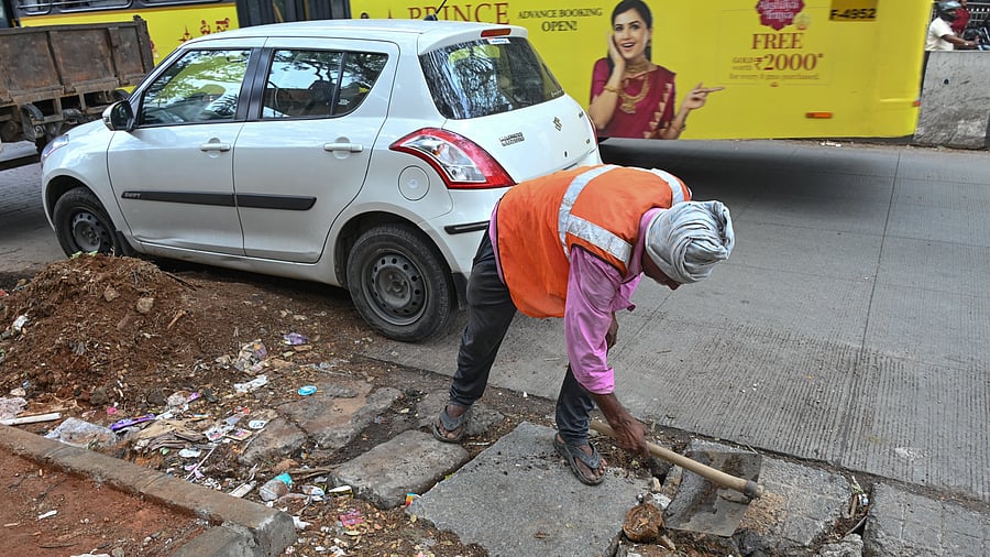 <div class="paragraphs"><p>A BBMP worker removes debris and mud from a drain opening near Madhavan Park, Jayanagar. </p></div>