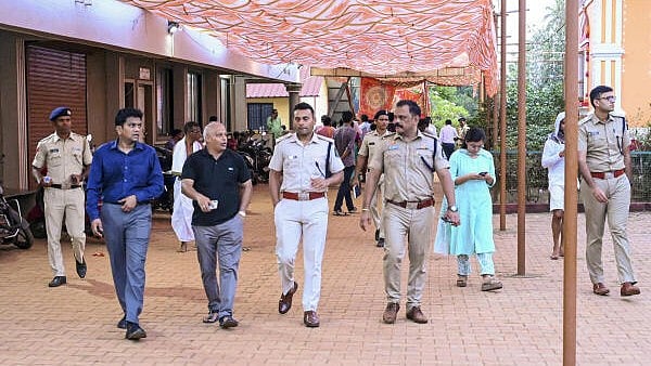 <div class="paragraphs"><p>Investigating officer Sandip Jacques (IAS) along with other government officials at the site after a stampede broke out at a village during a temple festival, in North Goa district, Saturday, May 3, 2025. At least six people were killed and more than 70 injured in the incident, officials said.</p></div>