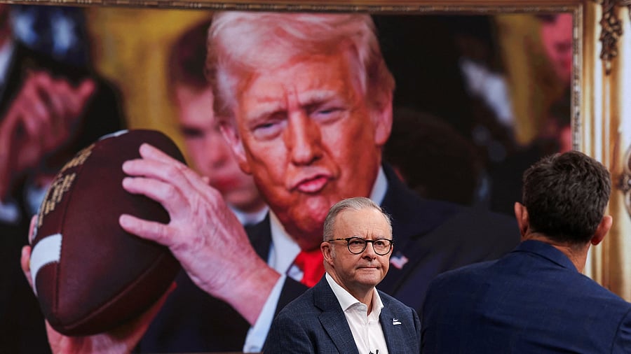 <div class="paragraphs"><p>Prime Minister Anthony Albanese looks on in front of an image of US President Donald Trump.</p></div>