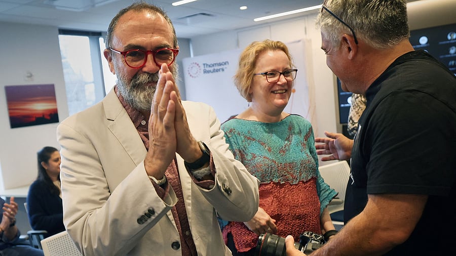 <div class="paragraphs"><p>Reuters journalist Maurice Tamman gestures as he stands with Senior Photographer Shannon Stapleton at right after the Reuters staff was awarded a Pulitzer Prize in the Investigative Reporting category for ‘Fentanyl Express’, a series of stories that penetrated the international trade in the chemicals used to make fentanyl, at the Reuters Newsroom in New York City, U.S., May 5, 2025. </p></div>