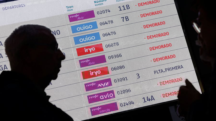 <div class="paragraphs"><p>An electronic board displays information about delays as passengers wait to be given access to their trains after a cable was stolen from a high-speed train line between Madrid and Andalusia at Atocha station in Madrid, Spain</p></div>