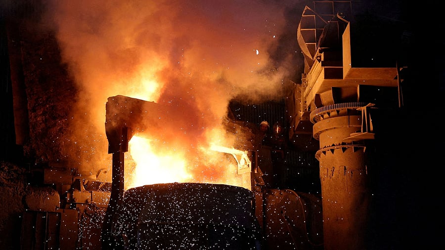 <div class="paragraphs"><p>FILE PHOTO: Employee fill melted steel into a container inside a steel bar manufacturing factory.</p></div>