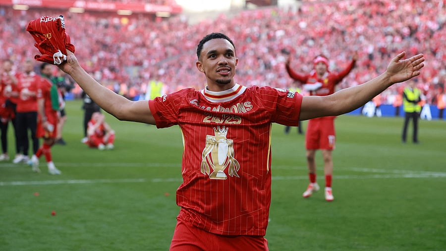 <div class="paragraphs"><p>Liverpool's Trent Alexander-Arnold celebrates after winning the Premier League </p></div>