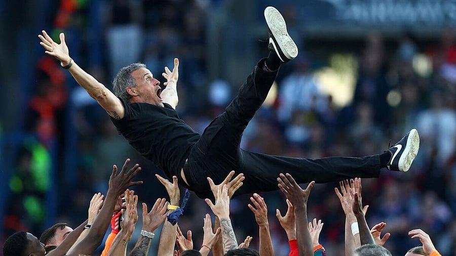 <div class="paragraphs"><p>Paris St Germain coach Luis Enrique celebrates with the players after winning Ligue 1.</p></div>