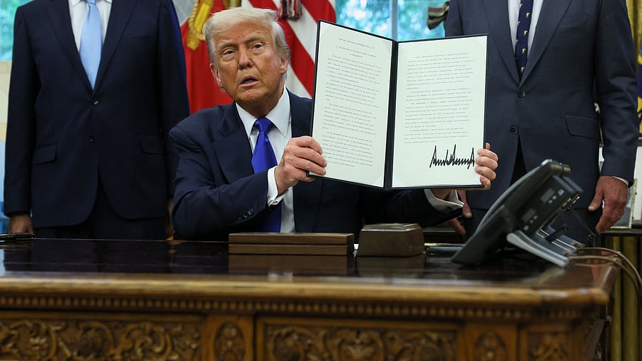 <div class="paragraphs"><p>U.S. President Donald Trump shows a signed document as he signs executive orders and proclamations in the Oval Office at the White House, in Washington, D.C., U.S., May 5, 2025. </p></div>