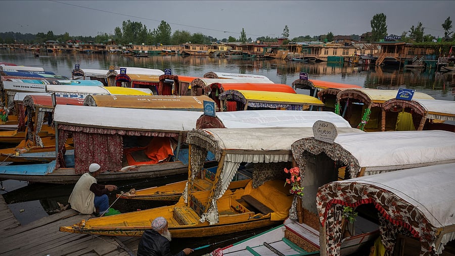 <div class="paragraphs"><p>Kashmiri men catch fish as they sit next to parked "Shikaras" or boats on the banks of Dal Lake in Srinagar, Kashmir, May 4, 2025. </p></div>