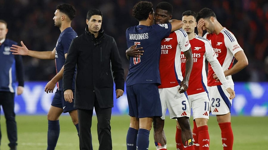 <div class="paragraphs"><p>St Germain's Marquinhos with Arsenal's Thomas Partey as Arsenal manager Mikel Arteta looks on after the match</p></div>