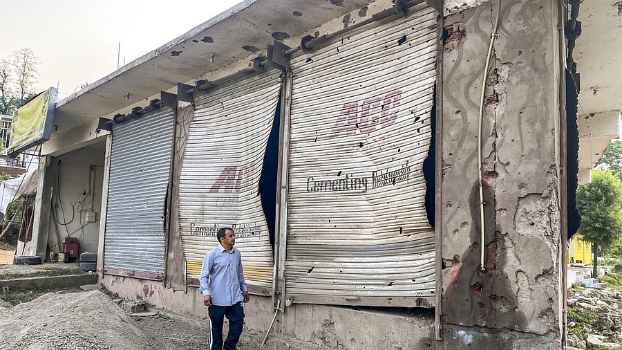 <div class="paragraphs"><p> A civilian looks at damaged properties after heavy firing and shelling by Pakistan military overnight across the Line of Control and International Border, at Mendhar area of Poonch district, Jammu and Kashmir, Wednesday, May 7, 2025.</p></div>