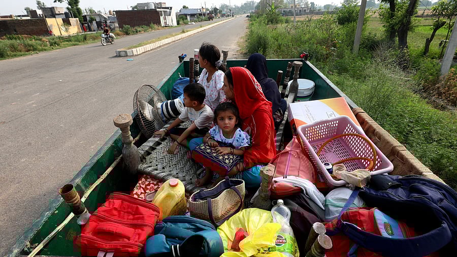 <div class="paragraphs"><p>Villagers sit in a tractor trolley as they move to safer places as authorities evacuate residents living near the International Border  with Pakistan, in Suchetgarh, in  Jammu and Kashmir, May 7, 2025. </p></div>