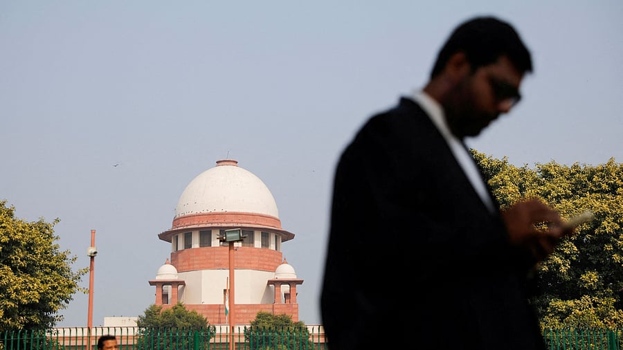 <div class="paragraphs"><p>A lawyer looks into his mobile phone in front of India's Supreme Court</p></div>