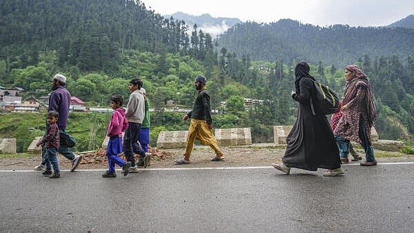 <div class="paragraphs"><p>People leave with their belonging for safe places following shelling by Pakistani troops.</p></div>