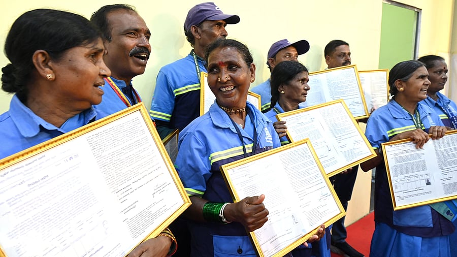<div class="paragraphs"><p>BBMP pourakarmikas showcase their recruitment letters during an event hosted by the Bruhat Bengaluru Mahanagara Palike to celebrate Pourakarmika Day in Palace Grounds on May 1.</p></div>