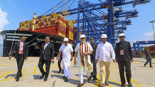<div class="paragraphs"><p>In this image released by PMO on May 2, 2025, Prime Minister Narendra Modi, Kerala Governor Rajendra Arlekar, Chief Minister Pinarayi Vijayan, Adani Group Chairman Gautam Adani and others at the newly-inaugurated Vizhinjam International Seaport, in Thiruvananthapuram. </p></div>