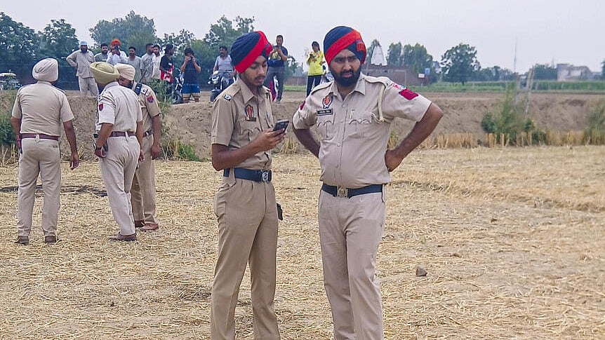 <div class="paragraphs"><p>Security personnel stand near the debris of an unidentified projectile which landed amid the conflict between India and Pakistan, in Jalandhar, Punjab.</p></div>