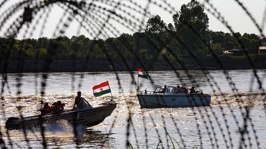 <div class="paragraphs"><p>Border Security Force (BSF) soldiers patrol on a boat in the Chenab river.</p></div>