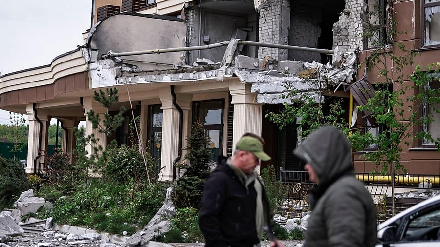 <div class="paragraphs"><p>Residents walk near the building hit by a Russian drone strike, amid Russia's attack on Ukraine,.</p></div>