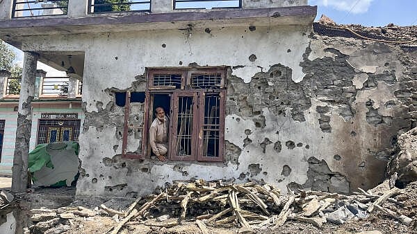 <div class="paragraphs"><p>A man stands inside a house damaged after cross border shelling by Pakistan, during the ongoing military conflict between India and Pakistan, at Behra village of Mendhar sector, in Poonch district, Jammu and Kashmir</p></div>
