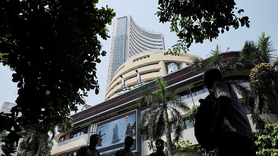 <div class="paragraphs"><p>Men walk past a screen displaying market results outside the Bombay Stock Exchange  in Mumbai.</p></div>