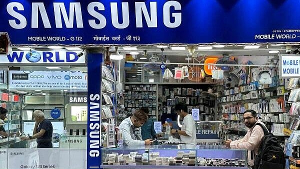 <div class="paragraphs"><p>People shop inside a store selling Samsung mobile phones and accessories in Mumbai</p></div>
