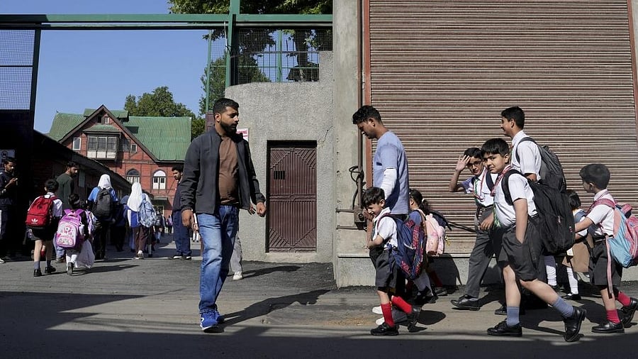 <div class="paragraphs"><p>Students head to their school as educational institutions reopen in non-border districts of Jammu and Kashmir after remaining closed for nearly a week due to India-Pakistan tensions, in Srinagar, Tuesday, May 13, 2025.</p></div>