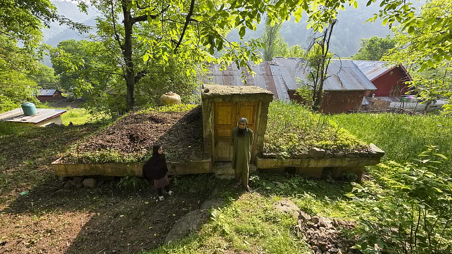 <div class="paragraphs"><p>People stand near an underground bunker </p></div>
