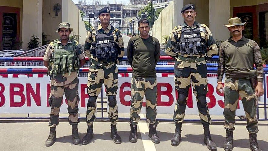 <div class="paragraphs"><p>Purnam Kumar Shaw, centre, with other BSF jawans after he was handed over by Pak Rangers via Attari-Wagah border in Punjab, Wednesday, May 14, 2025. He was apprehended by the Rangers on April 23 from along the Indo-Pak international border in Punjab.</p></div>