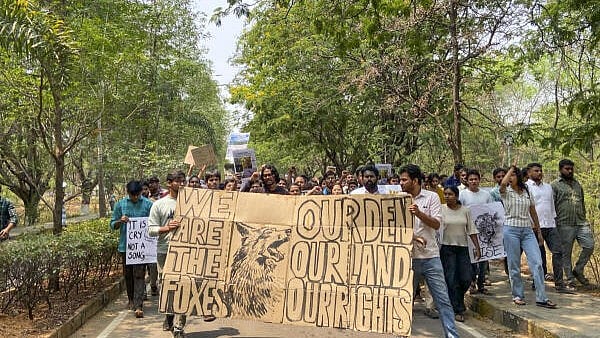 <div class="paragraphs"><p>Students of the University of Hyderabad stage a protest demanding the removal of police personnel and earth-moving machinery from the campus, in Hyderabad, Tuesday, April 1, 2025. The students are protesting against the Telangana government's plan to auction 400 acres of forested land in the Kancha Gachibowli area for the development of IT parks. </p></div>