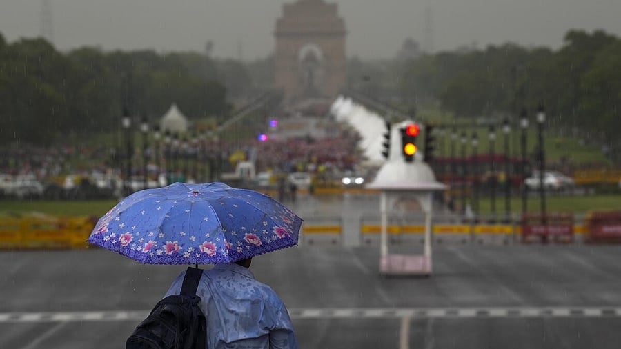 <div class="paragraphs"><p>A pedestrian amid rains, at Kartavya Path in New Delhi.&nbsp;</p></div>