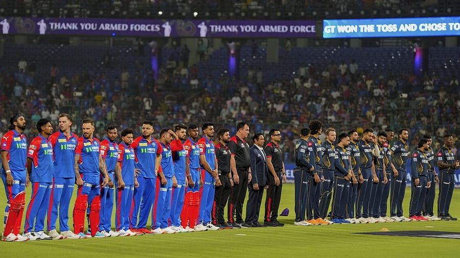 <div class="paragraphs"><p>Players of Delhi Capitals and Gujarat Titans stand during the national anthem in honour of the Indian armed forces, before an Indian Premier League (IPL) 2025 T20 cricket match between Delhi Capitals and Gujarat Titans, at the Arun Jaitley Stadium, in New Delhi, Sunday, May 18, 2025.</p></div>