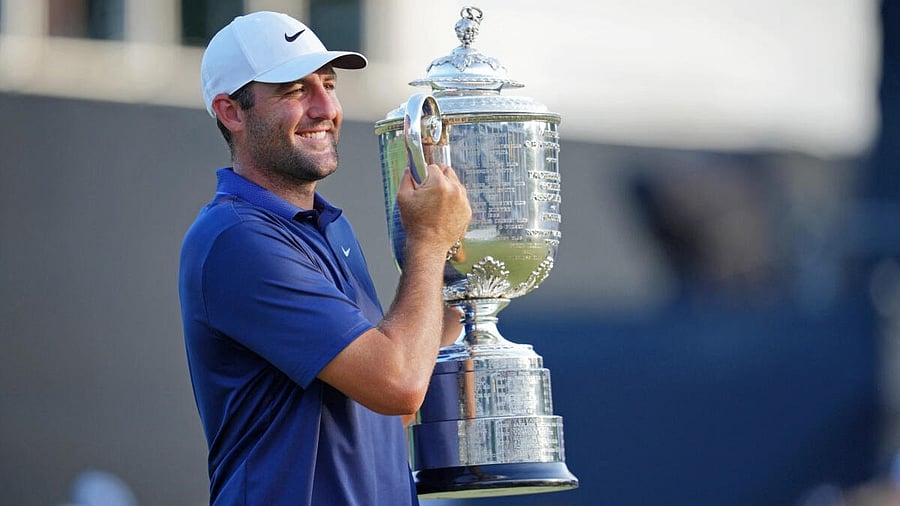 <div class="paragraphs"><p>Scottie Scheffler holds the Wanamaker Trophy after winning the PGA Championship golf tournament at Quail Hollow.</p></div>