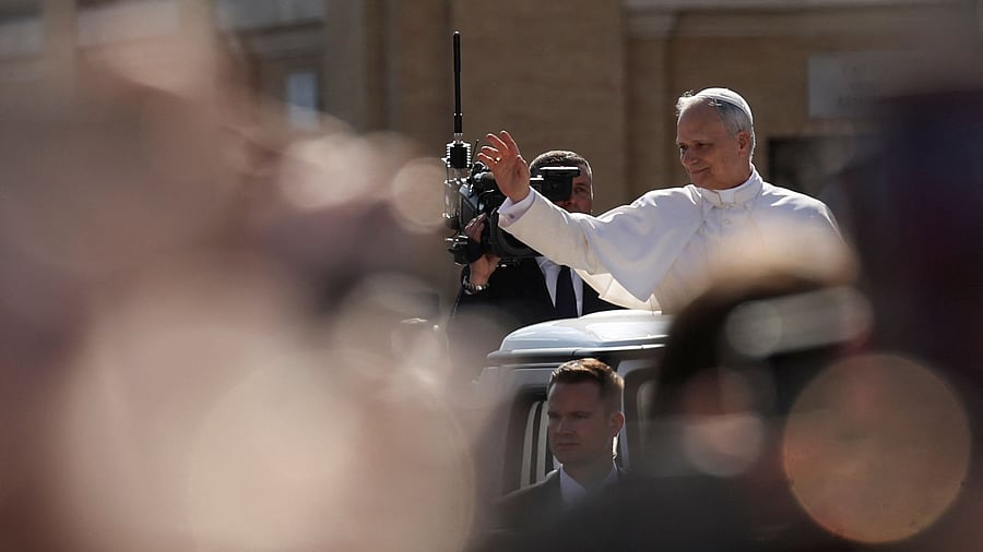 <div class="paragraphs"><p>Pope Leo XIV waves to people as he arrives on the popemobile for his inaugural Mass at the Vatican, May 18, 2025.</p></div>