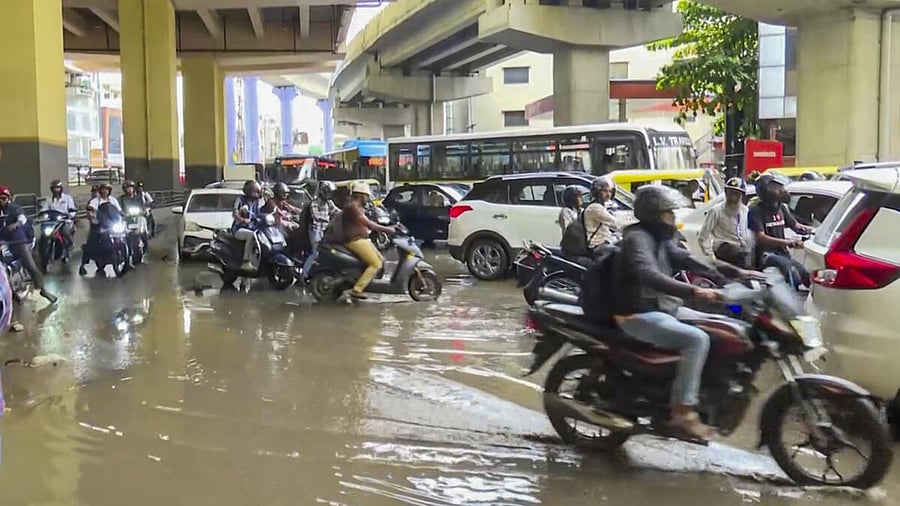 <div class="paragraphs"><p>Vehicles moves on a waterlogged road after rain, in Bengaluru</p></div>