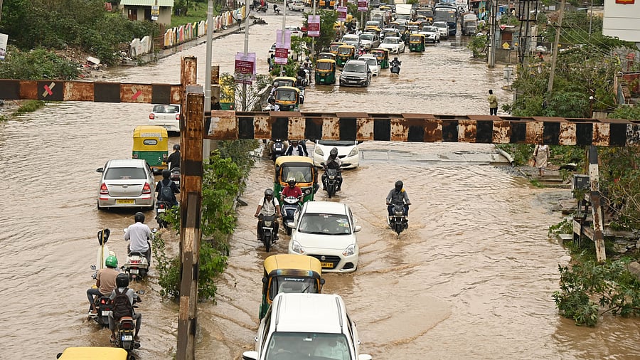 <div class="paragraphs"><p>Vehicles navigating a waterlogged street at Hennur on Monday, following the overnight downpour.&nbsp;</p></div>