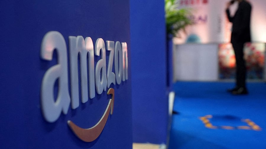 <div class="paragraphs"><p>A visitor stands near a logo of Amazon</p></div>