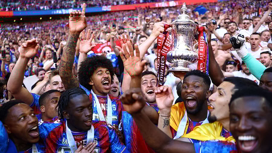<div class="paragraphs"><p>Crystal Palace's Joel Ward celebrates with teammates and the trophy after winning the FA Cup, May 17, 2025.</p></div>
