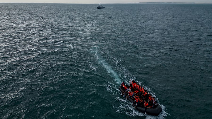 <div class="paragraphs"><p>In this drone view, an inflatable dinghy carrying migrants makes its way towards England in the English Channel, Britain.</p></div>