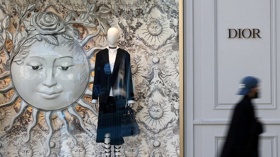 <div class="paragraphs"><p>A man walks past a shop of fashion house Dior in Paris, France.</p></div>