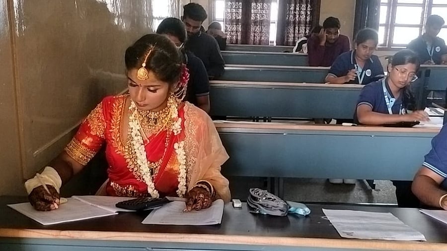 <div class="paragraphs"><p>Kavana appears for the exam immediately after her wedding in Hassan on Thursday. </p></div>