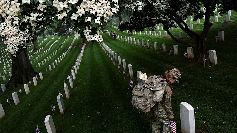 <div class="paragraphs"><p>A soldier from the U.S. Army 3d Infantry Regiment, known as The Old Guard, participates in the annual 'Flags-In' event, where U.S. flags are placed at service members' gravesites, in advance of Memorial Day at Arlington National Cemetery in Arlington, Virginia, U.S., May 22, 2025. </p></div>