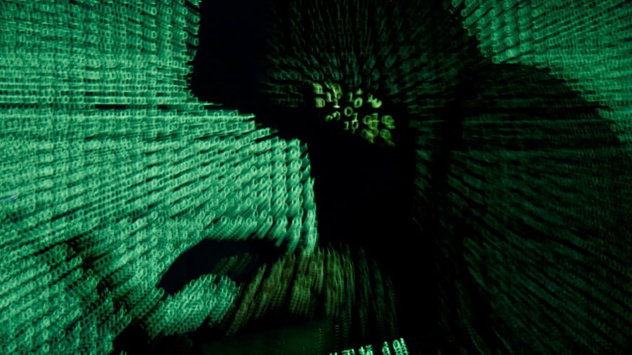 <div class="paragraphs"><p>A man holds a laptop computer as cyber code is projected on him in this illustration</p></div>